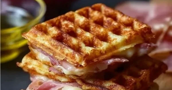 Herzhafte Waffeln mit Schinken und Käse auf einem Teller serviert